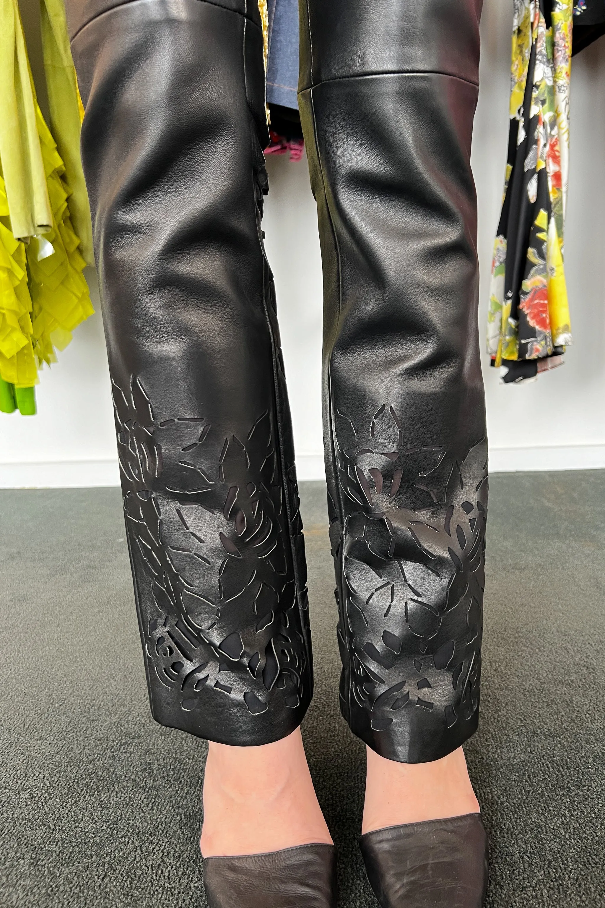 VERSACE BLACK LEATHER PANTS WITH FLORAL LASER CUTOUTS